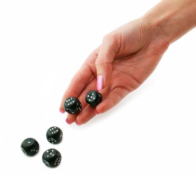 Female hand rolling black dice isolated on a white background