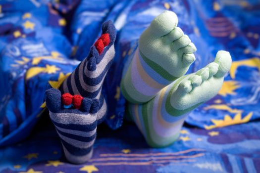 Stock photo: an image of two pairs of feet in striped socks
