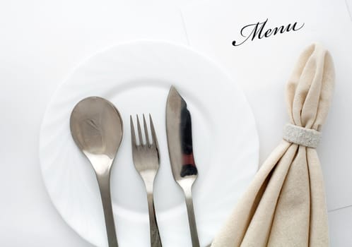 An image of fork, spoon and knife with napkin