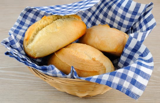 Fresh bread in a basket with a napkin shelter