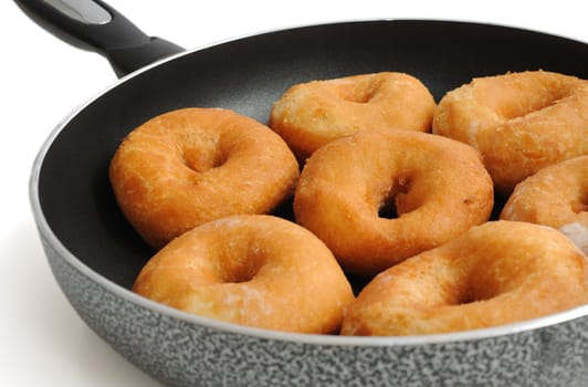 Doughnuts fried in a pan close-up