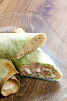 spinach tortilla filled with salmon and mozzarella