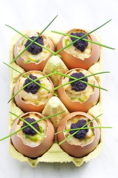 scrambled eggs with chives and black caviar