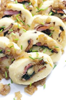 roll from potato dough filled with spinach and bacon