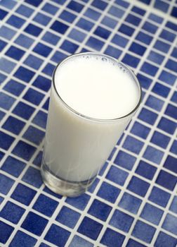 Glass of Milk towards blue mosaic