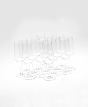 Glasses of champagne on white background