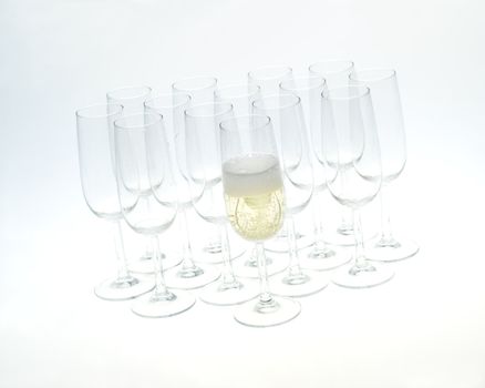 Glasses of champagne on white background