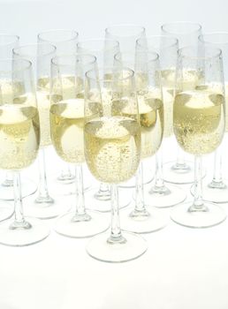 Glasses of champagne on white background