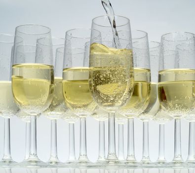 Glasses of champagne on white background