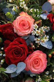 Flower arrangement with big pink and red roses