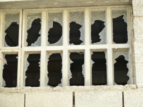 brokwn vandalised windows on a disused building
