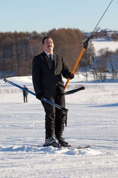 Man in business sute on ski lift