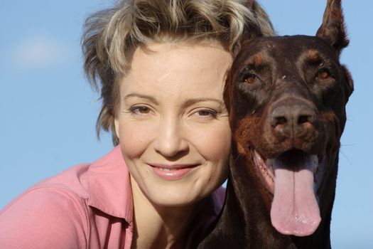 Young woman with old dobermann dog