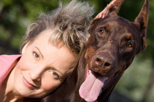 Young woman with old dobermann dog