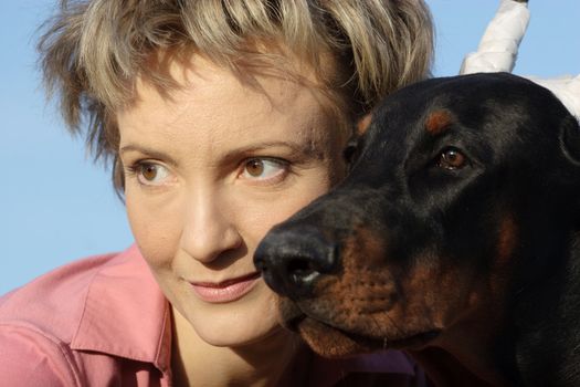 Young woman with old dobermann dog