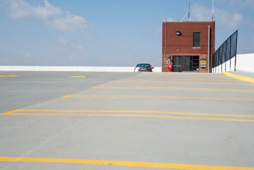 One car stands alone on an almost empty parking deck.