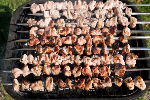 A barbecue meat slices prepare on fire