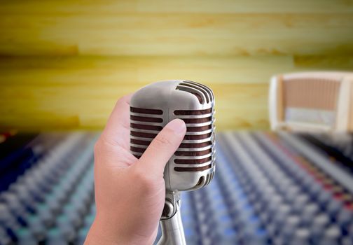 hand holding microphone in sound record room
