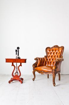 vintage luxury armchair and telephone in white room