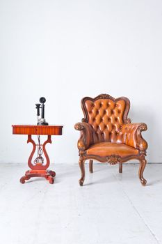 vintage luxury armchair and telephone in white room