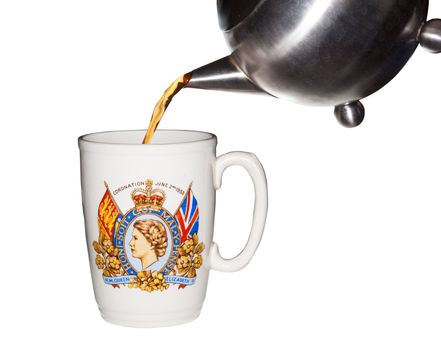 Old coronation cup  from crowning of Queen Elizabeth with tea being poured from teapot