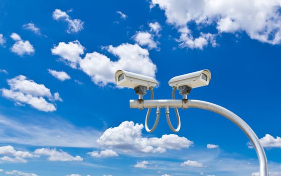 surveillance cameras against blue sky