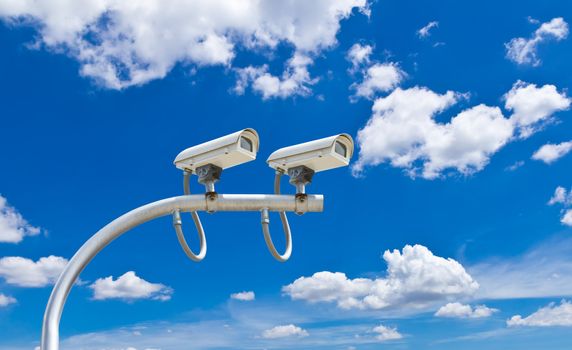 surveillance cameras against blue sky