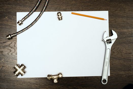 plumbing tools on a white sheet of paper, place for text