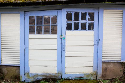 Couple of old weathered Blue Bordered  Garage Doors