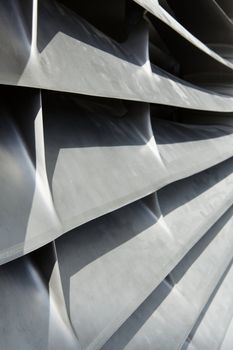 Close-up image of the inlet silvery metallic inlet vanes of an aircraft jet engine
