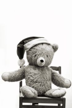 An image of bear toy in christmas hat