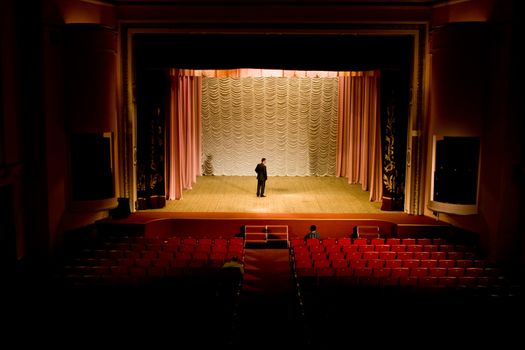 Stock photo: an image of a man on the stage in empty hall