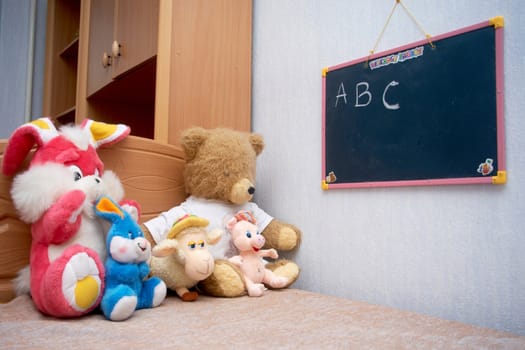 A toys sitting at the blackboard