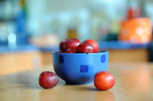 An image of a bowl with fresh tasty plums