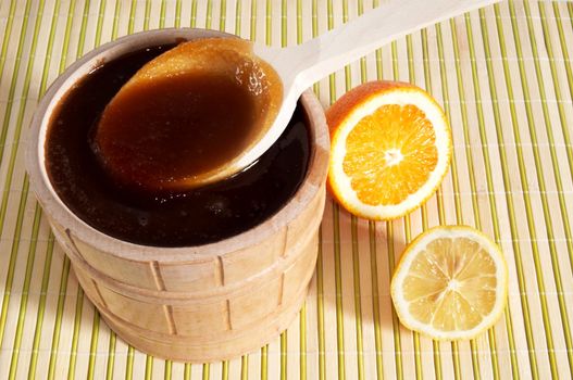 A pail with honey and slice of lemon