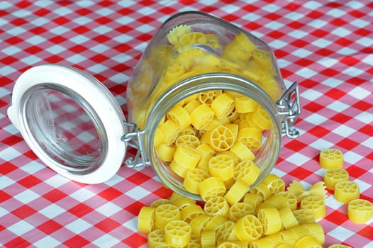 An image of bright yellow pasta in a jar