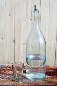 An image of a half-full bottle and a glass