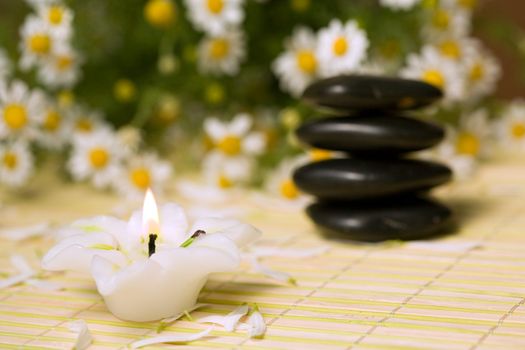 An image of stones for spa massage and candle