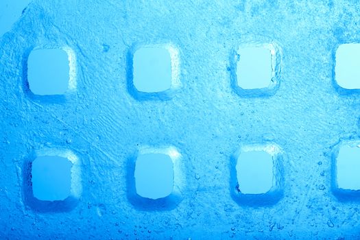 An image of plate of blue ice with "windows"
