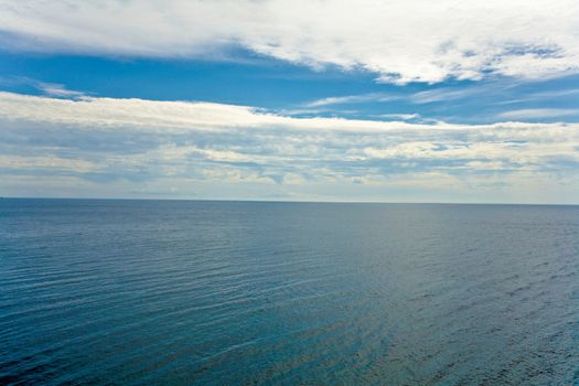 image of blue water under the sky with clouds