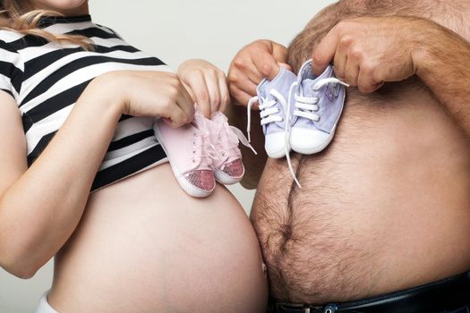 An image of man and woman with little shoes