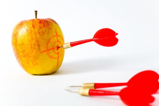 Red-yellow Apple with Darts on White Background