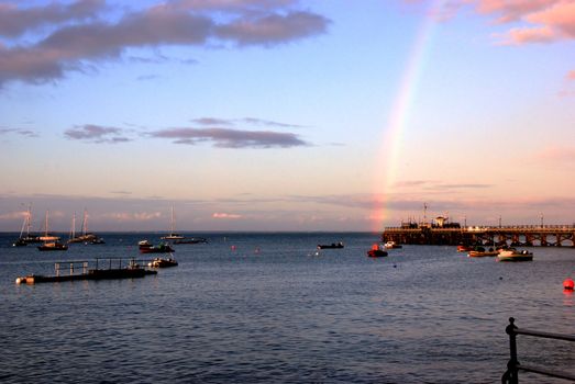 Sunset and rainbow over the pier at Swanage