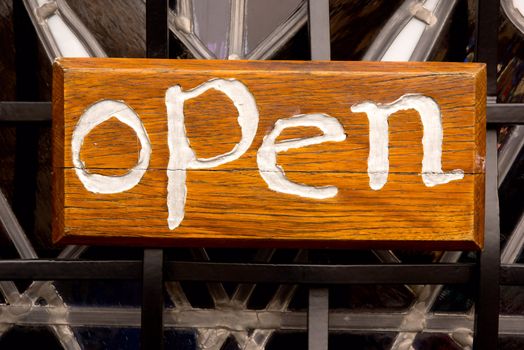 Open sign against a fence