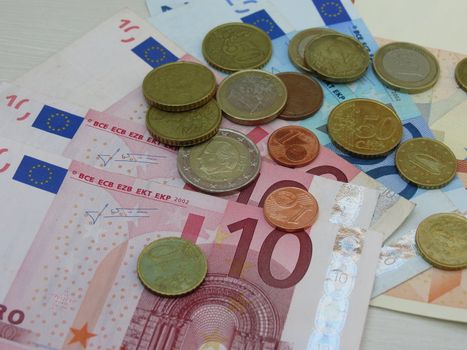 Euro (EUR) banknotes and coins money useful as a background or money concept