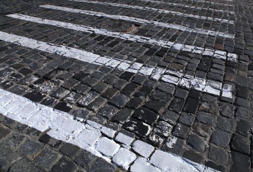 paving stones texture with painted white pedestrian crossing