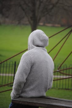 man standing backwards in the hood