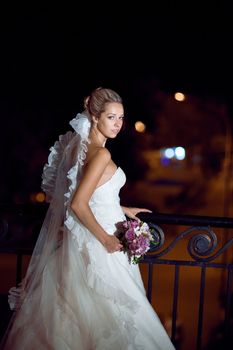 bride at night by the railing