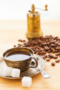 A cup of coffe with coffee bean as background. Vertical view