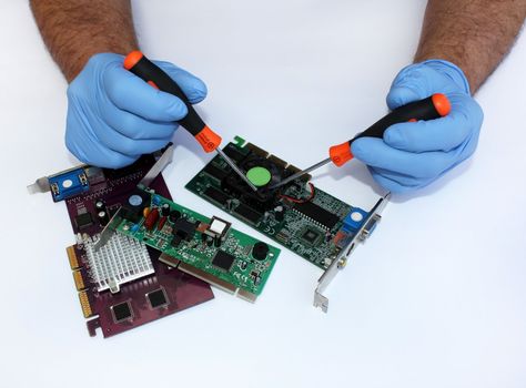 Men's gloved hands repairing computer components